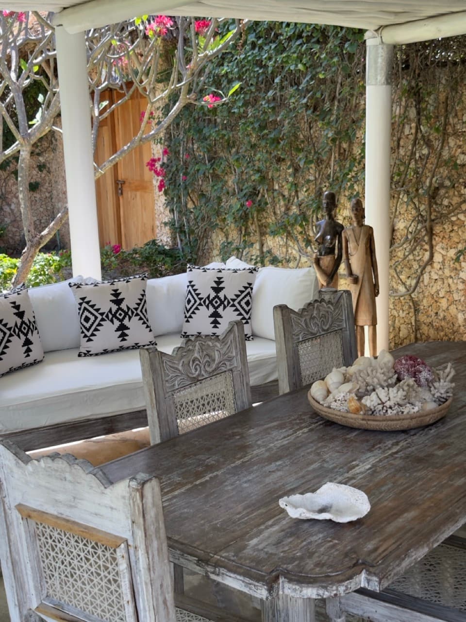 Outdoor relax corner with coral and seashell decor, Villa Chris House Watamu