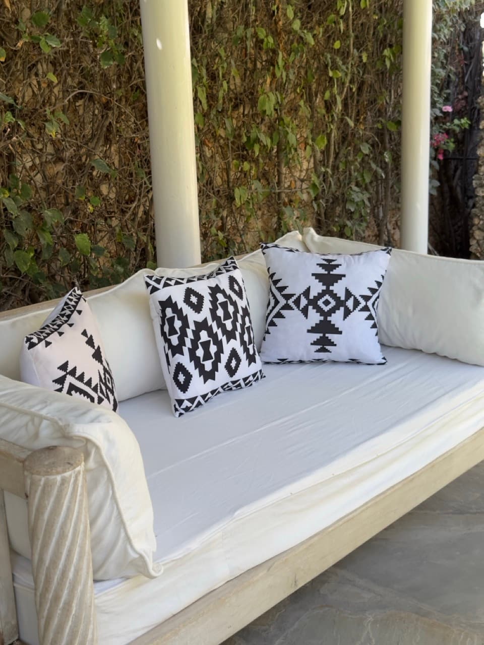 Outdoor sofa with ethnic cushions in the villa's garden in Watamu